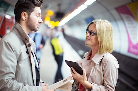Business people talking in subway station Stock Photo - Premium Royalty-Free, Code: 6113-07961670