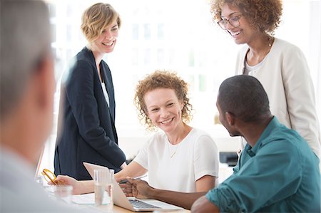 Group of office workers talking at desk Stock Photo - Premium Royalty-Free, Code: 6113-07991897