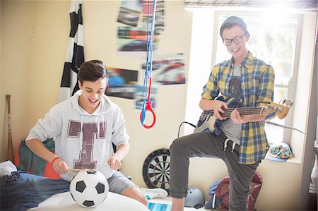 Two teenage boys playing music in room Stock Photo - Premium Royalty-Free, Code: 6113-07991987