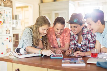 south africa - Group of teenagers using together digital tablet at table in kitchen Stock Photo - Premium Royalty-Free, Code: 6113-07992005