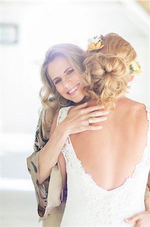 Portrait of smiling matron of honor embracing bride Stock Photo - Premium Royalty-Free, Code: 6113-07992153