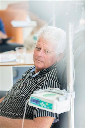 Senior man receiving intravenous infusion in hospital Stock Photo - Premium Royalty-Free, Code: 6113-07905861