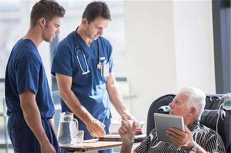 dr talking to patient - Patient using tablet pc and talking to doctors in hospital Stock Photo - Premium Royalty-Free, Code: 6113-07905875