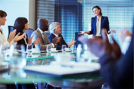 simsearch:6108-06907153,k - Business people meeting in conference room, woman standing giving speech Stock Photo - Premium Royalty-Free, Code: 6113-07906053