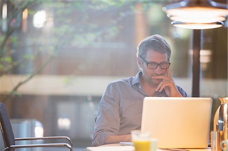 Businessman working on laptop in office Stock Photo - Premium Royalty-Free, Code: 6113-07906250