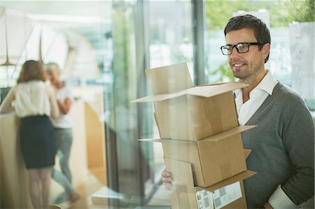 person with boxes - Businessman carrying cardboard boxes in office Stock Photo - Premium Royalty-Free, Code: 6113-07906309