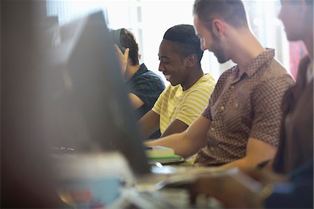 University students talking and studying on computers in classroom Stock Photo - Premium Royalty-Free, Code: 6113-07906470