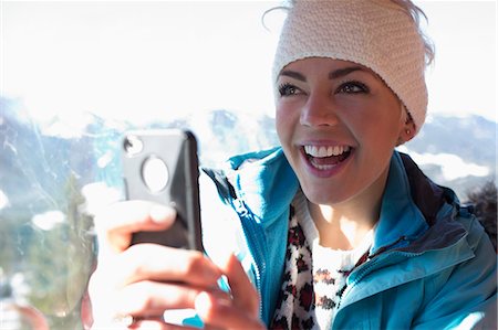 sports and skiing - Smiling woman using cell phone Stock Photo - Premium Royalty-Free, Code: 6113-07906571