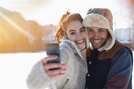 filipino - Couple taking selfie in snow Stock Photo - Premium Royalty-Free, Code: 6113-07906579