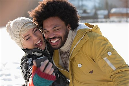 simsearch:6113-06899345,k - Happy couple taking selfie in snow Stock Photo - Premium Royalty-Free, Code: 6113-07906589