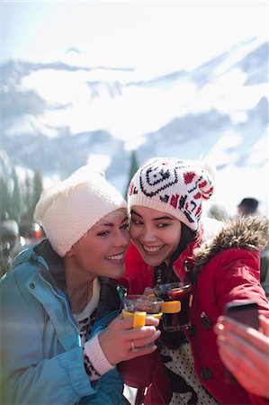 simsearch:6113-06899345,k - Smiling women in warm clothing drinking tea outdoors Stock Photo - Premium Royalty-Free, Code: 6113-07906643