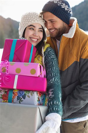 Couple with Christmas gifts in snow Stock Photo - Premium Royalty-Free, Code: 6113-07906671