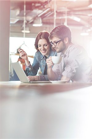 Casual business people working at laptop in office Stock Photo - Premium Royalty-Free, Code: 6113-08087860