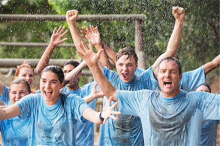 simsearch:6113-07648679,k - Enthusiastic team cheering in rain on boot camp obstacle course Stock Photo - Premium Royalty-Free, Code: 6113-08087971