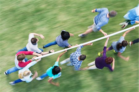 simsearch:6113-06499188,k - Team running and balancing pole on fingertips Stock Photo - Premium Royalty-Free, Code: 6113-08087976