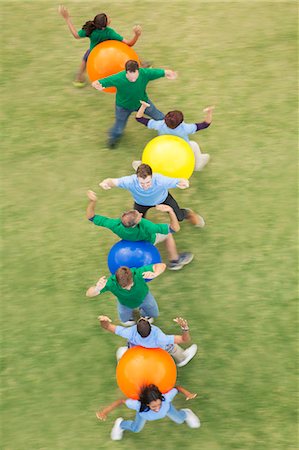 simsearch:6113-07589120,k - Teammates performing fitness ball team building activity Stock Photo - Premium Royalty-Free, Code: 6113-08087909