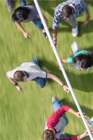 simsearch:6113-07589120,k - Team running and balancing pole on fingertips Stock Photo - Premium Royalty-Free, Code: 6113-08087913