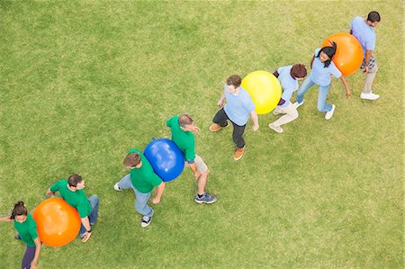 simsearch:6113-07589120,k - Teammates performing fitness ball team building activity Stock Photo - Premium Royalty-Free, Code: 6113-08087915