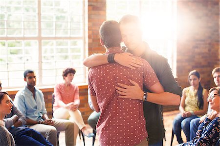 supportive hug - Men hugging at group therapy session Stock Photo - Premium Royalty-Free, Code: 6113-08087932