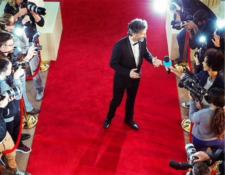 simsearch:6113-08088218,k - Celebrity on red carpet being interviewed and photographed by paparazzi Stock Photo - Premium Royalty-Free, Code: 6113-08088142
