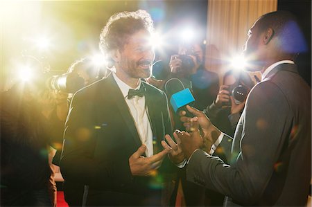 flash (camera flash) - Celebrity being interviewed and photographed by paparazzi at event Stock Photo - Premium Royalty-Free, Code: 6113-08088155