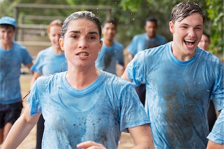 Determined woman running on boot camp obstacle course Stock Photo - Premium Royalty-Free, Code: 6113-08088100