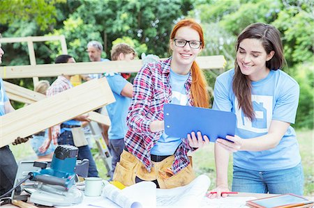 Volunteers with clipboard talking at construction site Stock Photo - Premium Royalty-Free, Code: 6113-08088136