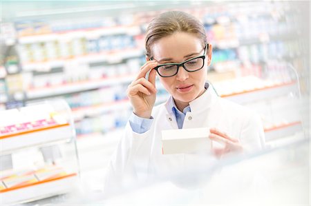 entry field - Pharmacist reading label on box in pharmacy Stock Photo - Premium Royalty-Free, Code: 6113-08088403
