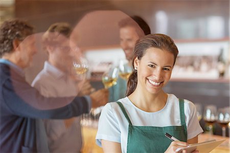 Portrait smiling worker with clipboard in winery tasting room Stock Photo - Premium Royalty-Free, Code: 6113-08171157