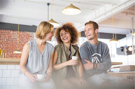 simsearch:6113-07148073,k - Laughing friends drinking coffee in cafe Stock Photo - Premium Royalty-Free, Code: 6113-08171318