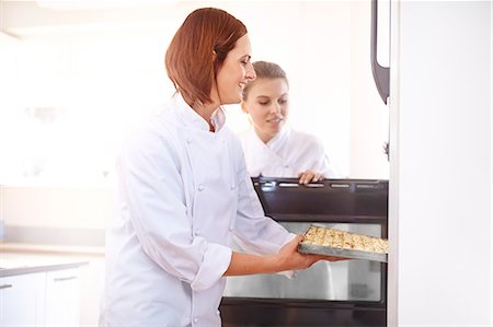 simsearch:649-06165027,k - Chefs placing tray in oven Stock Photo - Premium Royalty-Free, Code: 6113-08171521