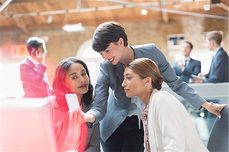 simsearch:6113-06899131,k - Businesswomen texting with cell phone in office Stock Photo - Premium Royalty-Free, Code: 6113-08184297