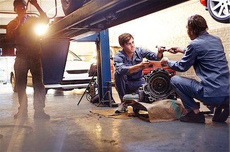 fixing - Mechanics discussing part in auto repair shop Photographie de stock - Premium Libres de Droits, Code: 6113-08184352