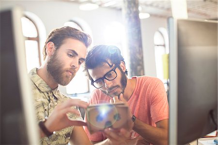 design - Creative businessmen reviewing proofs at computers in sunny office Stock Photo - Premium Royalty-Free, Code: 6113-08105416