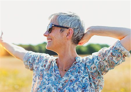 energy mature outdoors - Enthusiastic senior woman with arms outstretched in sunny field Stock Photo - Premium Royalty-Free, Code: 6113-08220214