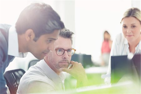 speaking - Business people working at computer in sunny office Stock Photo - Premium Royalty-Free, Code: 6113-08220317