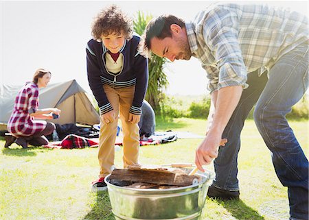 Father and son building campfire Stock Photo - Premium Royalty-Free, Code: 6113-08393798