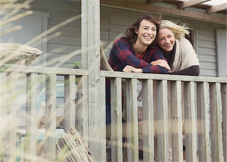 Portrait smiling mother and daughter on porch Stock Photo - Premium Royalty-Free, Code: 6113-08393736