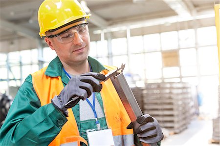 steel worker - Worker in protective workwear examining part in factory Stock Photo - Premium Royalty-Free, Code: 6113-08393840