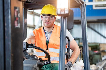 Portrait worker driving forklift in factory Stock Photo - Premium Royalty-Free, Code: 6113-08393817