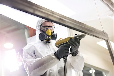 respirator - Worker in protective workwear using drill in factory Stock Photo - Premium Royalty-Free, Code: 6113-08393829