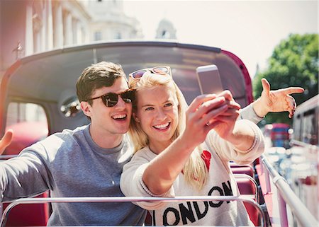 double decker bus - Couple taking selfie on double-decker bus in London Stock Photo - Premium Royalty-Free, Code: 6113-08321094