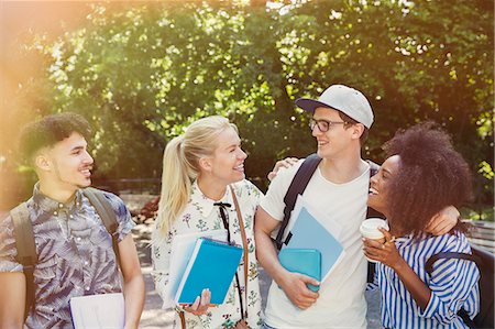simsearch:6113-07542497,k - College students with books and coffee walking in park Stock Photo - Premium Royalty-Free, Code: 6113-08321192