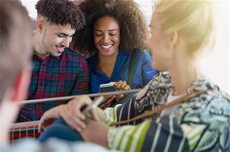 Friends texting with cell phone on bus Stock Photo - Premium Royalty-Free, Code: 6113-08321218