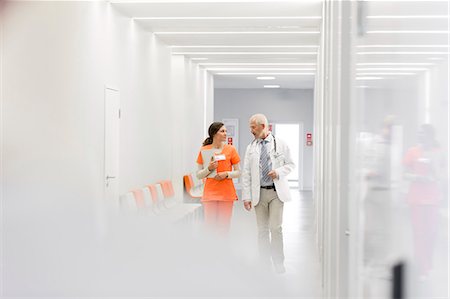 doctor nurse walking - Doctor and nurse making rounds in hospital corridor Stock Photo - Premium Royalty-Free, Code: 6113-08321347