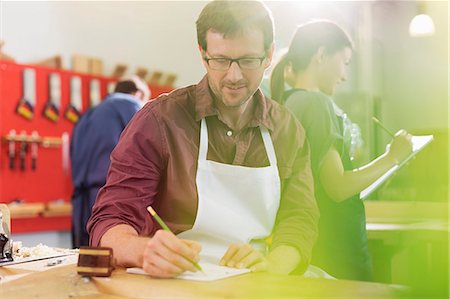 single mature people - Carpenter drafting plans in workshop Stock Photo - Premium Royalty-Free, Code: 6113-08321453