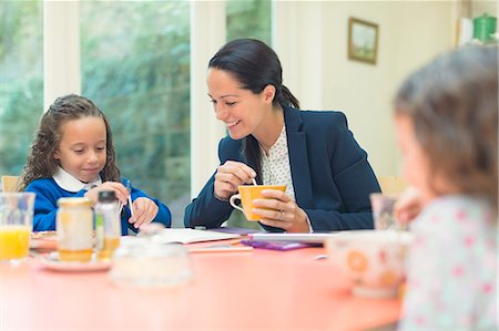 simsearch:628-07072734,k - Working mother and daughter doing homework at breakfast table Stock Photo - Premium Royalty-Free, Code: 6113-08321632
