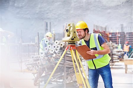 reflective clothing - Engineer with clipboard using theodolite at construction site Stock Photo - Premium Royalty-Free, Code: 6113-08321760