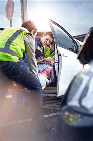 Rescue workers removing car accident victim from car Stock Photo - Premium Royalty-Free, Code: 6113-08321701