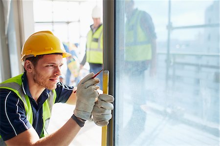 Construction worker measuring window at construction site Stock Photo - Premium Royalty-Free, Code: 6113-08321717